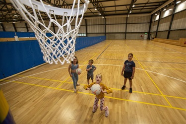 View from the net of children practising their netball shooting