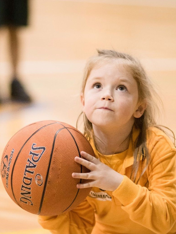 Girl shooting basketball.png