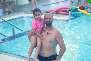 Image of parent and child enjoying the pools