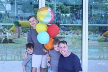Image of a family with balloons enjoying time at the aquatic centre
