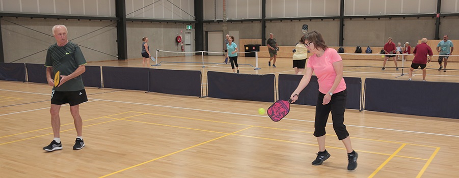 People playing on an indoor pickleball court