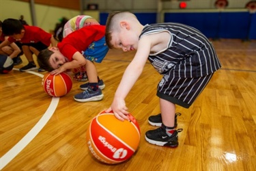 little kids learning to spin a basketball