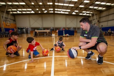 teaching little children basketball