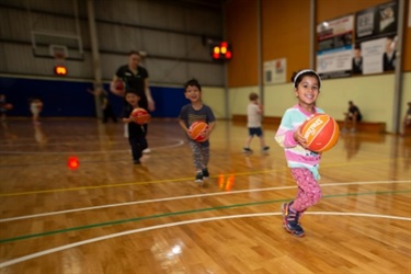 little kids running on basketball court