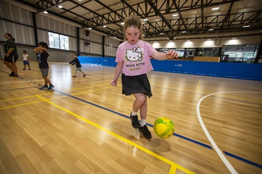 Youth practises kicking a futsal ball