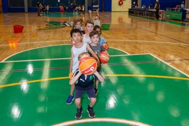 group of children lining up to take a shot